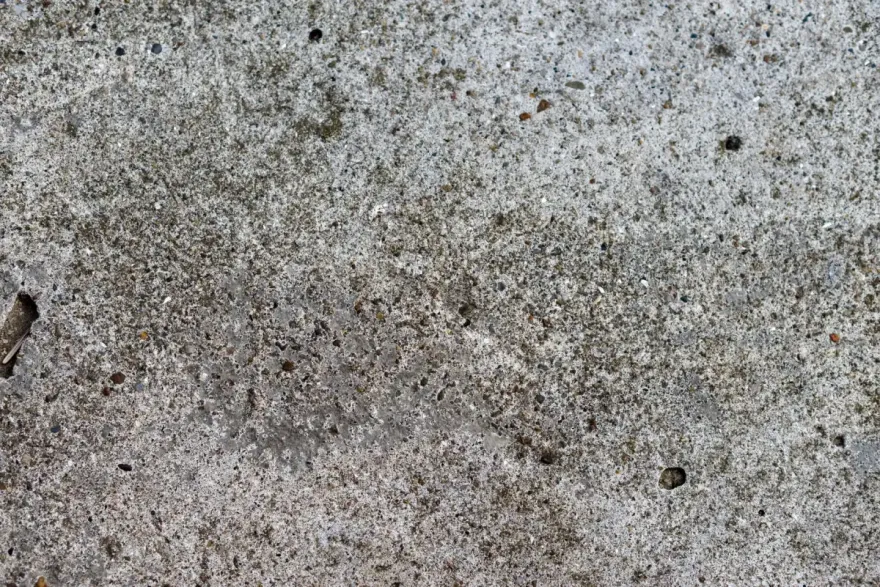Concrete surface worn back to its sand and aggregate by scaling